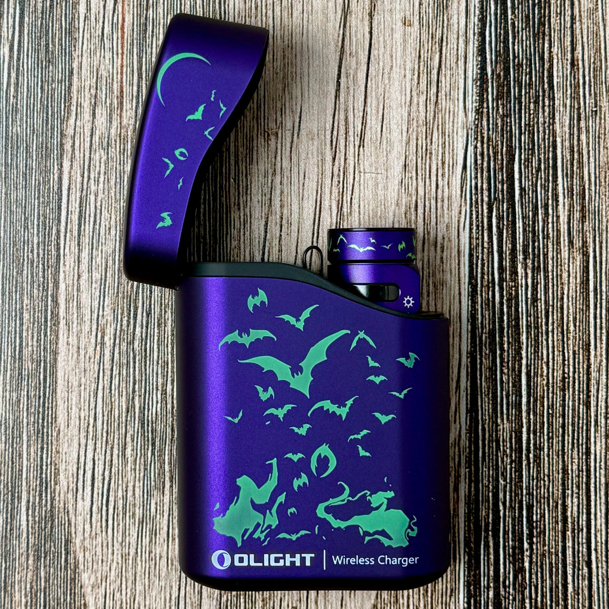 Olight Baton 4 Nocturnal Sentinel flashlight seated in its open purple charging case
